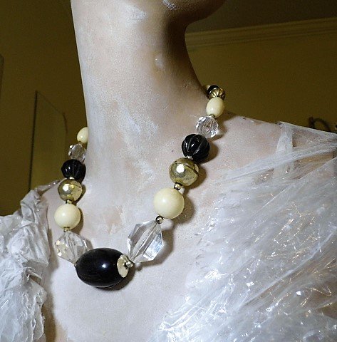 Bovine Horn & French Faux Ivory Fetish Necklace: Odd mix of lucite, genuine cow horn and composition elements. About 21 inches. Wire strung. Good clasp. Little tarnish to silver tone elements.