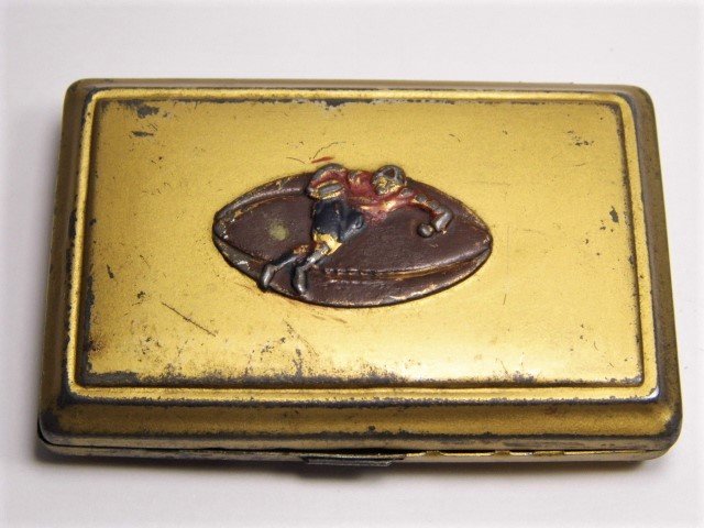 Early Football England Made Box With Something Inside: Sports memorabilia of some kind. Appears to be a rugby player and ball. However, rugby is not played with pads and helmet. Interior of box states British Made. No idea. Box structurally sound, snaps s