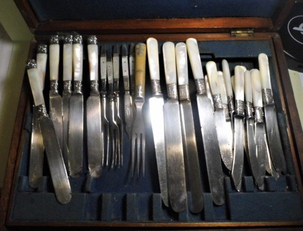 Box Mother of Pearl Silverware Mixed Remnants: Silver plate with wear and tarnish, but some good pieces mixed in. 28 pieces in all. Seven pieces are fish forks and knives. Some marked Meriden 1855. The embossed bands are genuine whole silver. Can