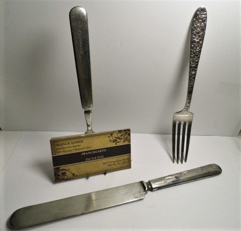 Interesting Beautiful Antique American Flatware Items: A circa 1900 Rogers & Son café fork which has been repurposed as a cardholder, marked Surfside Café. An early 20th century very ornate handle dinner fork marked National Silver Plate. A donner knife