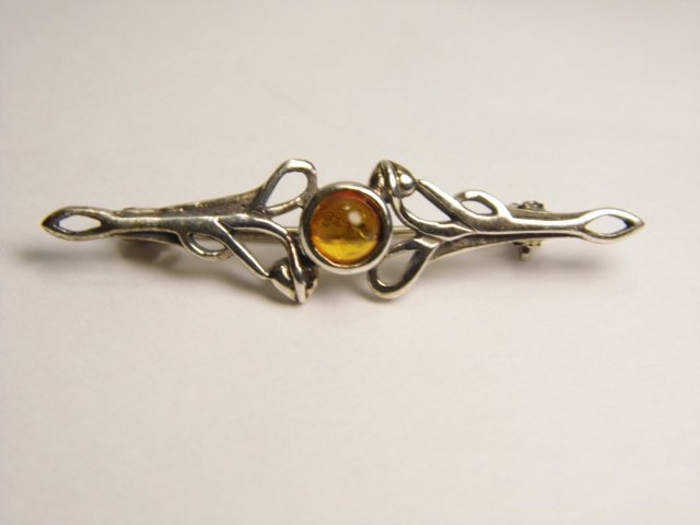 Mysterious Sterling Silver & Amber Brooch: Gothic influence. Brooch has 925 sterling silver mark on back. Amber stone with inclusions. Clasp good.