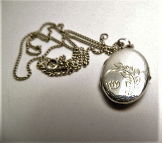 Vintage Sterling Silver Double Locket Pendant Necklace: Sixteen inch chain marked on clasp. Chased locket has good hinge. Snaps shut.