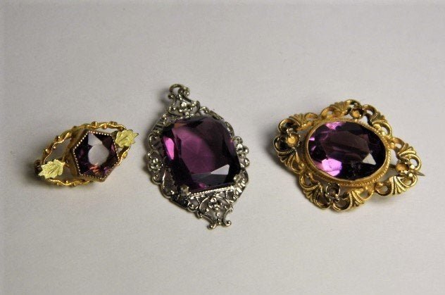 Three Beautiful Antique Pinchbeck Pins Cut Amethyst: The larger pin has an amethyst paste stone. The two smaller pins have genuine amethyst stones.