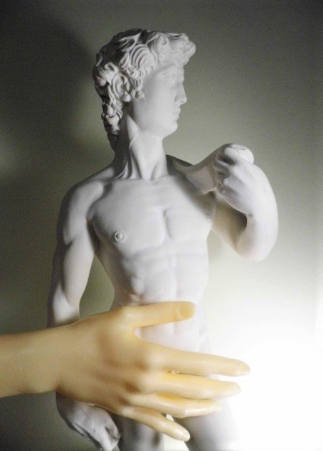 Excellent Stone Statue Mickey's David Wow: Really striking likeness of Michelangelo's sculpture of David during the time of his struggle with Goliath. David has his sling over the shoulder. Historical rumor has is that Michelangelo's ruler was