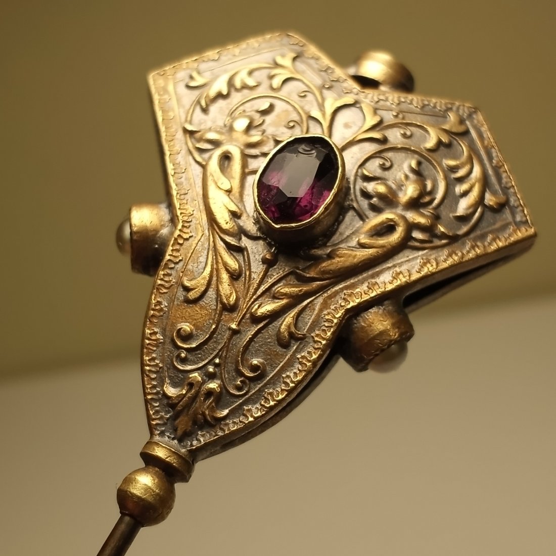 A Fine French Antique Ormolu Bronze Hatpin: With hand cut amethysts and small pearls. One of the amethysts has a chip. 11 inches.