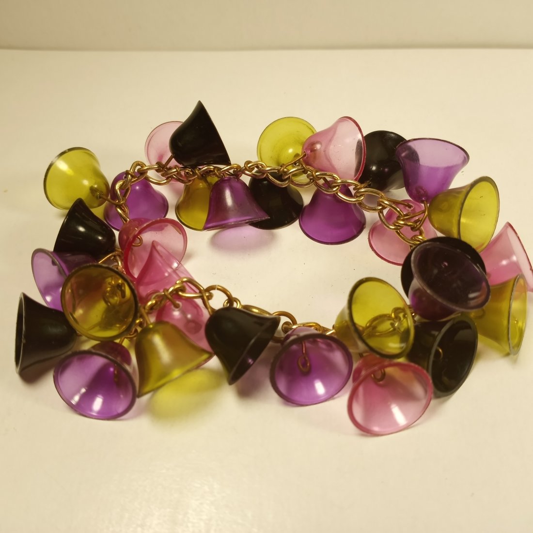 Beautiful Vintage Bells Bracelet: Appears to be a paste/glass material. Not resin. None of the bells broken. Jingle a little.