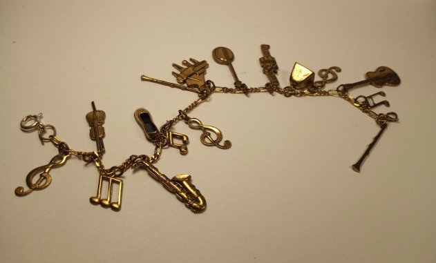Vintage Musiciansl Charm Bracelet: All brass charms. 16 altogether.