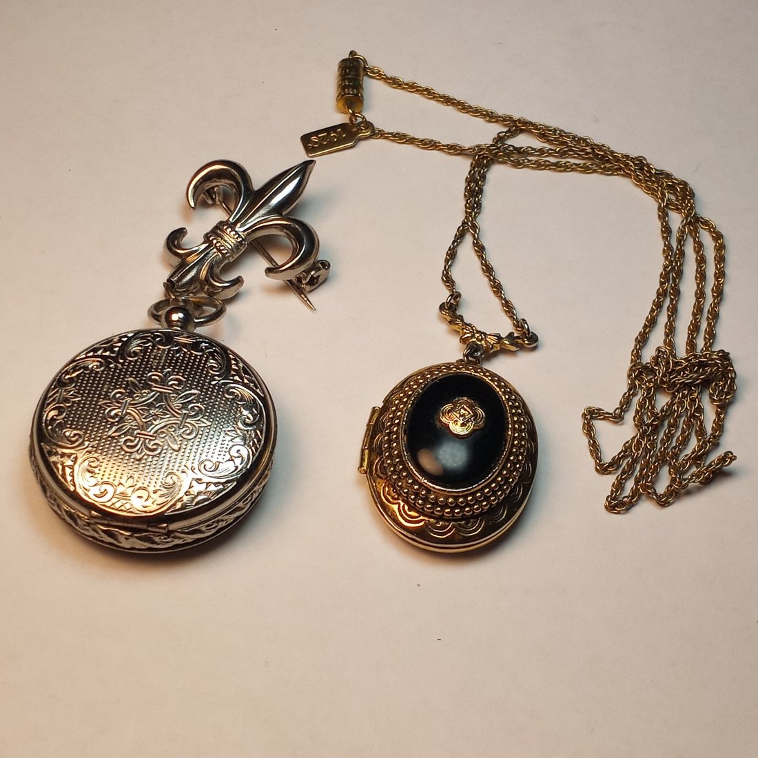 Locket Pendant Necklace and Coro Lavalier Locket: Both are double lockets in fine condition. The Coro locket opens like a watch by pushing the plunger at top.