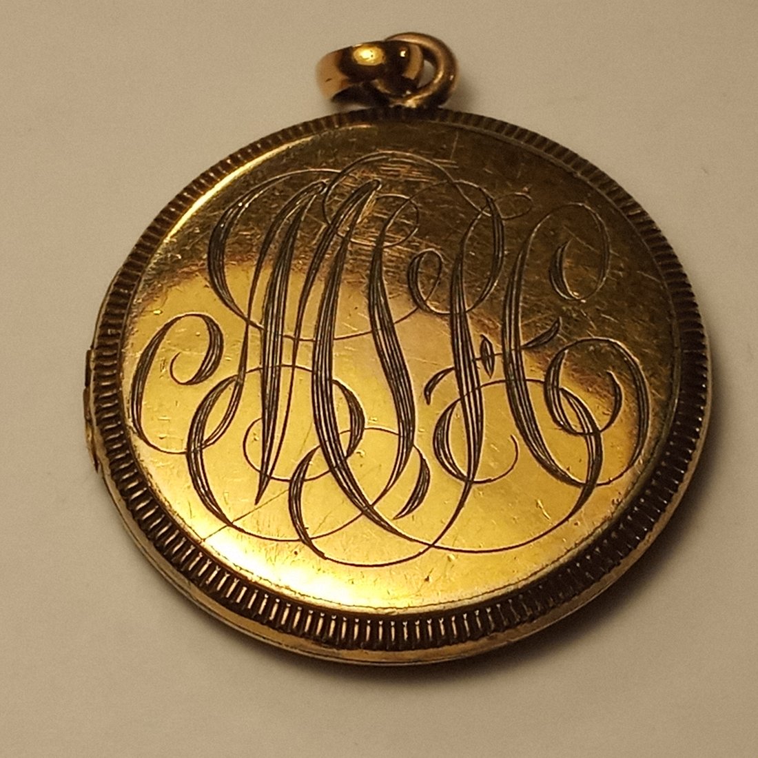 Antique Gold Plated Locket: Calligraphy engraved both sides. Clean. Good hinge. Snaps shut.