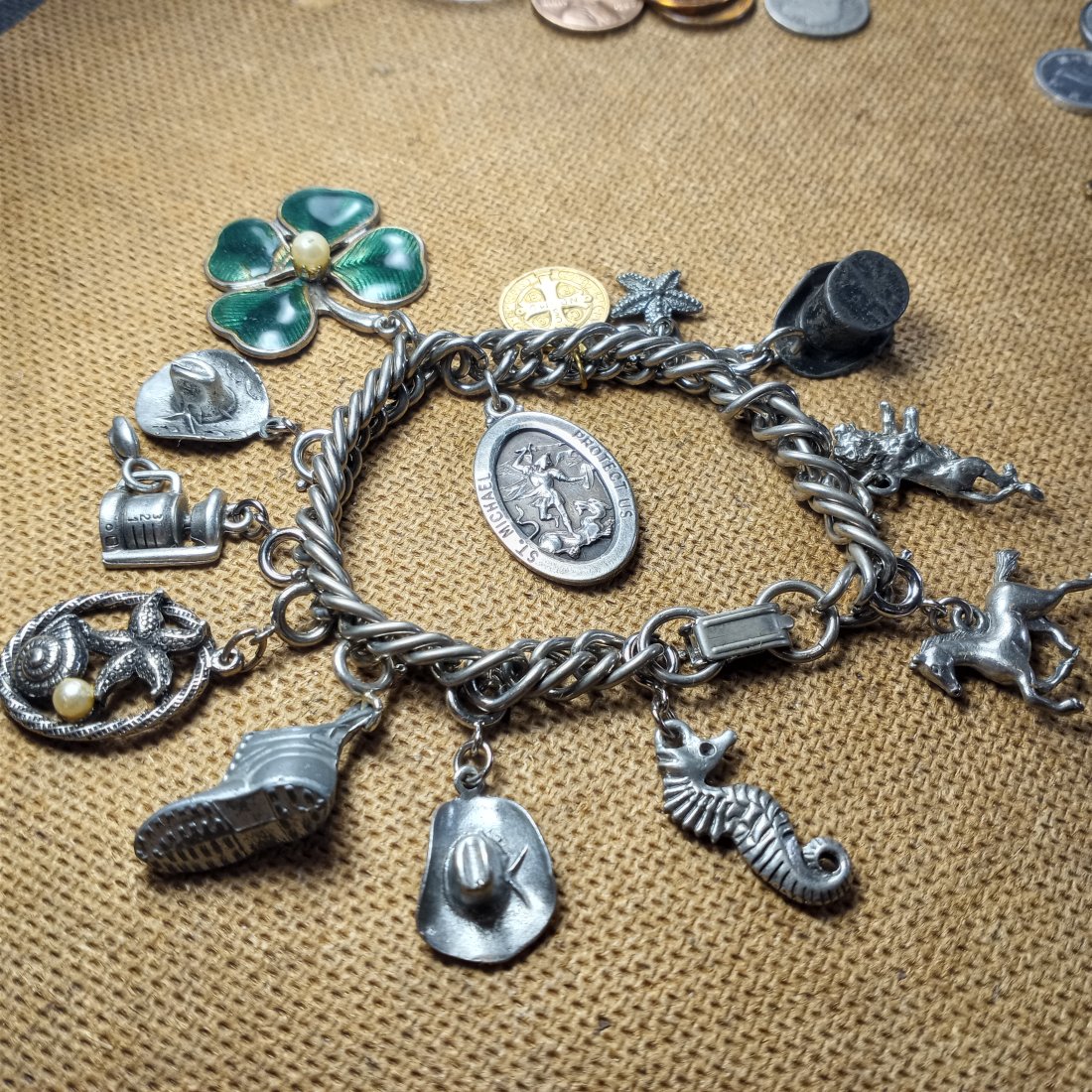 Vintage Charm Bracelet: A few of the charms are silver. Mostly pewter. Good clasp.