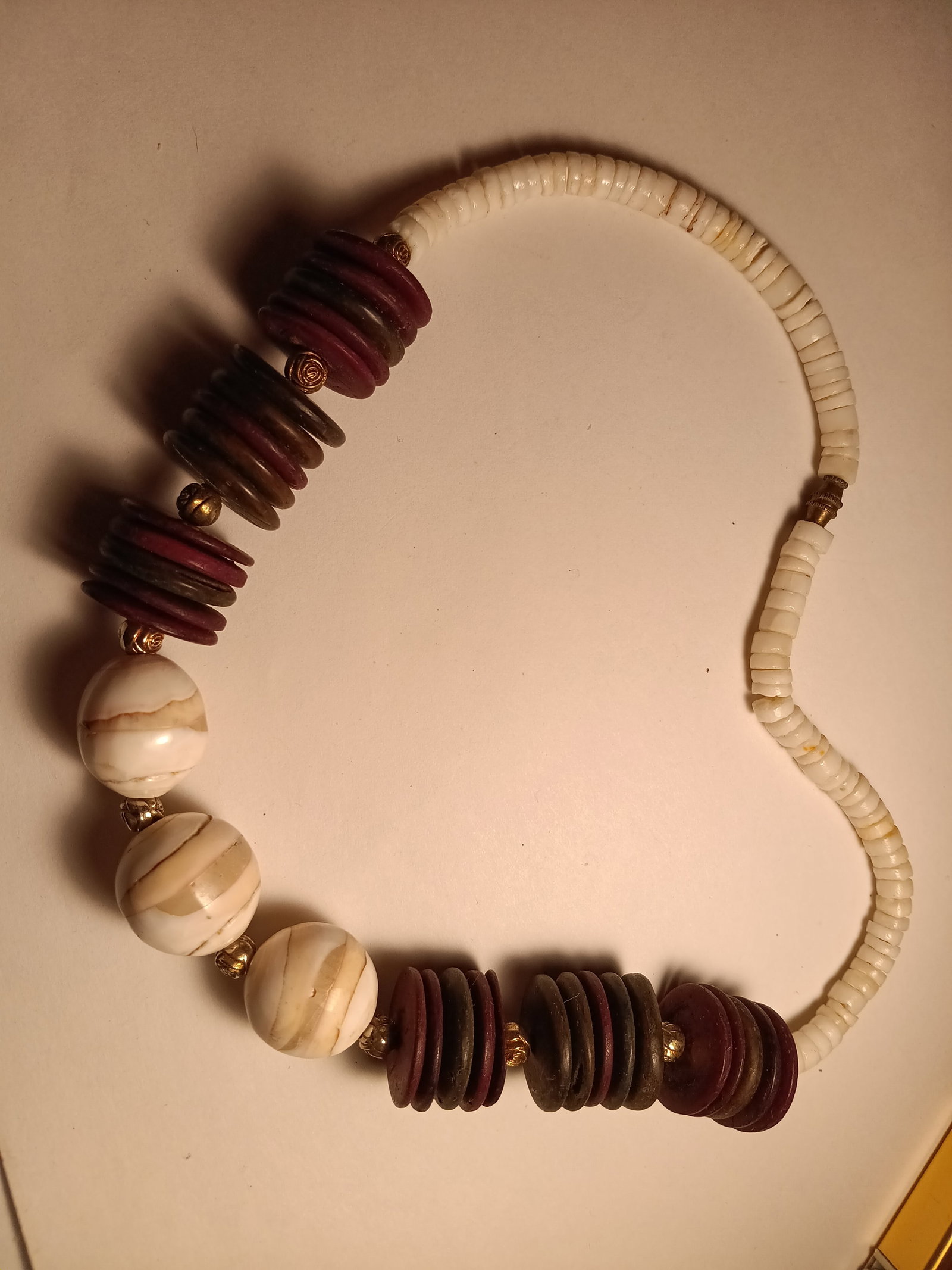 Unique Conch and Heishi Bead Necklace: The red disks are made of wood. 17 inches. Good clasp. No issues.