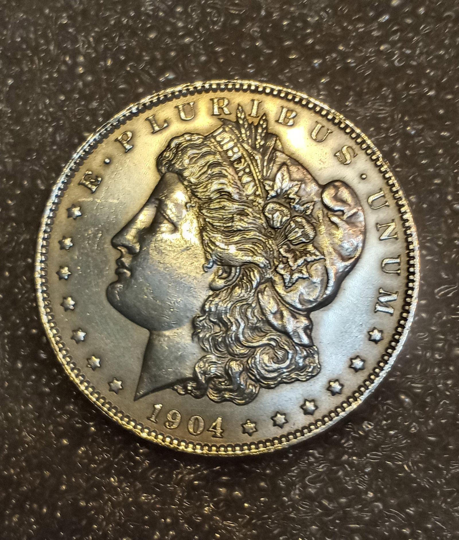 1904 O American Morgan Silver Dollar: 90% silver. Bold strike. Near uncirculated. New Orleans mint mark.