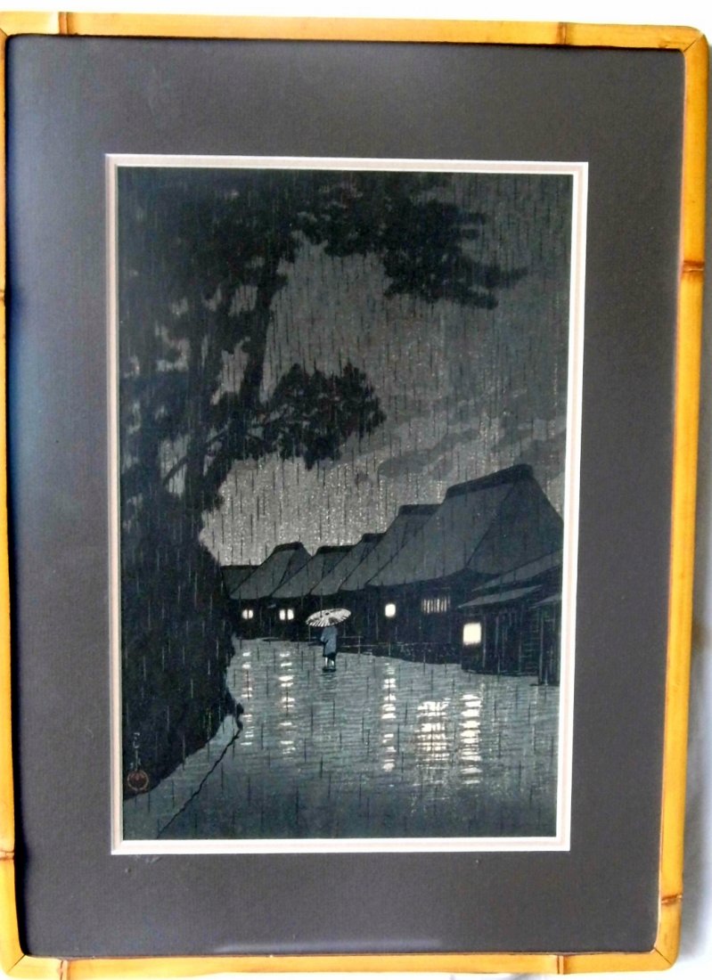Kawase Hasui Japanese Woodblock Print: Kawase Hasui 1883-1957. Titled 'Rain at Okutama River'. Housed in a custom frame made exactly for viewing the special nature of woodblock prints. A dovetailed, split bamboo veneered frame measures 20 