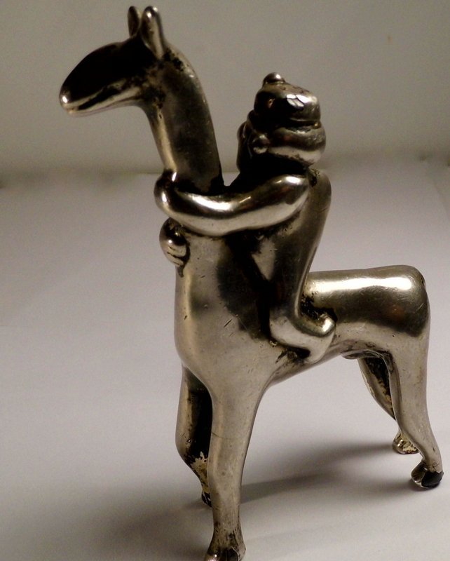 Heavy Silver Plated Incan Figurine Hunchback on Llama: Hunchbacks were often seen as Shaman in ancient indian culture. Their presence could bring good fortune. Measures about 4 inches longest and tallest. Has a feint mark of some kind under foot.