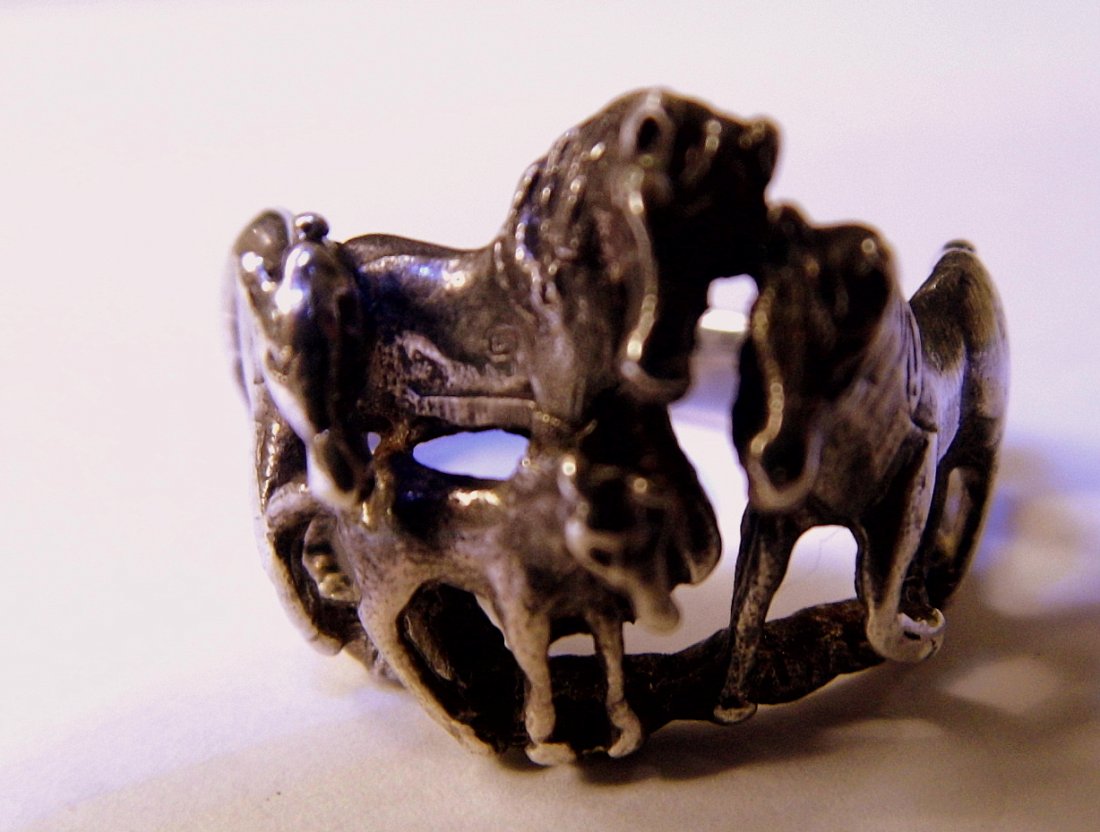 Southwestern Sterling Silver Ring 4 Horses: Finely cast sterling silver ring signed OTT with a copyright mark. Depicts four horses appearing to be a stud, mare, yearling and foal horse.