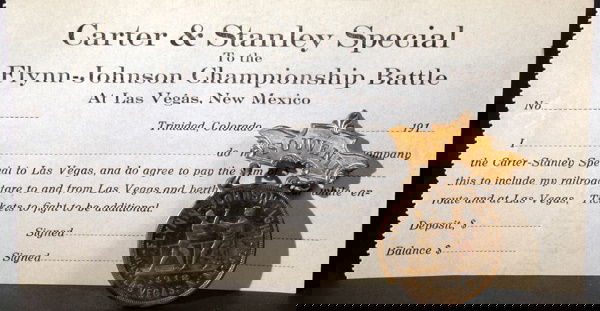 1912 Jack Johnson Souvenir Pin Flynn Fight: Souvenir pin from Jack Johnson-Jim Flynn in Las Vegas, New Mexico in 1912. Comes with blank Carter & Stanley train pass to the fight.