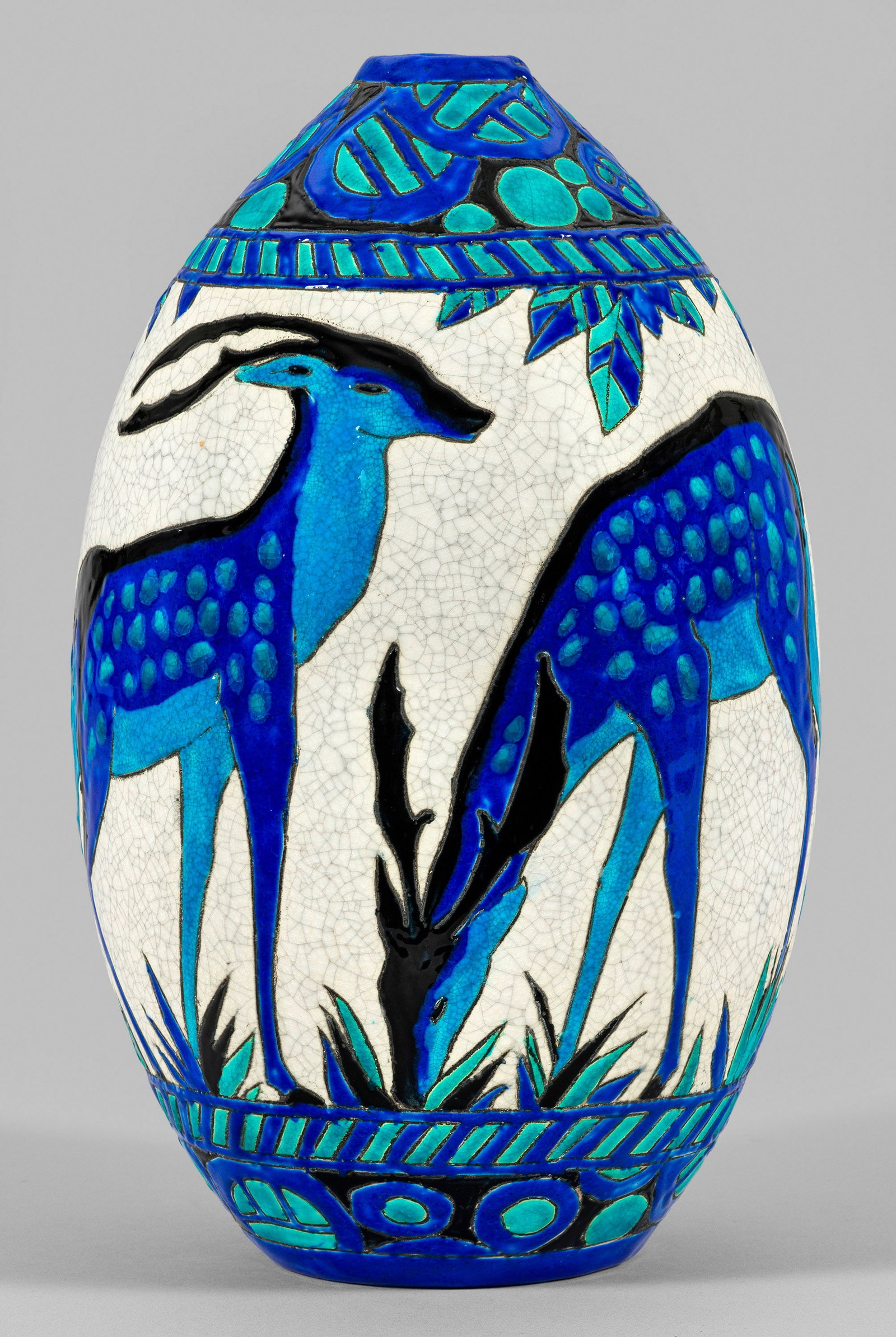 Art Déco-Vase mit Tierdekor: Steingut mit heller Krakelee-Glasur. Ovoider Korpus. Umlaufend der Wandung grasendes Rehwild. Oberhalb Ornamentbordüre. Farbkräftiger Emaildekor in Türkis, Blau und Schwarz. Entw. Charles Catteau.