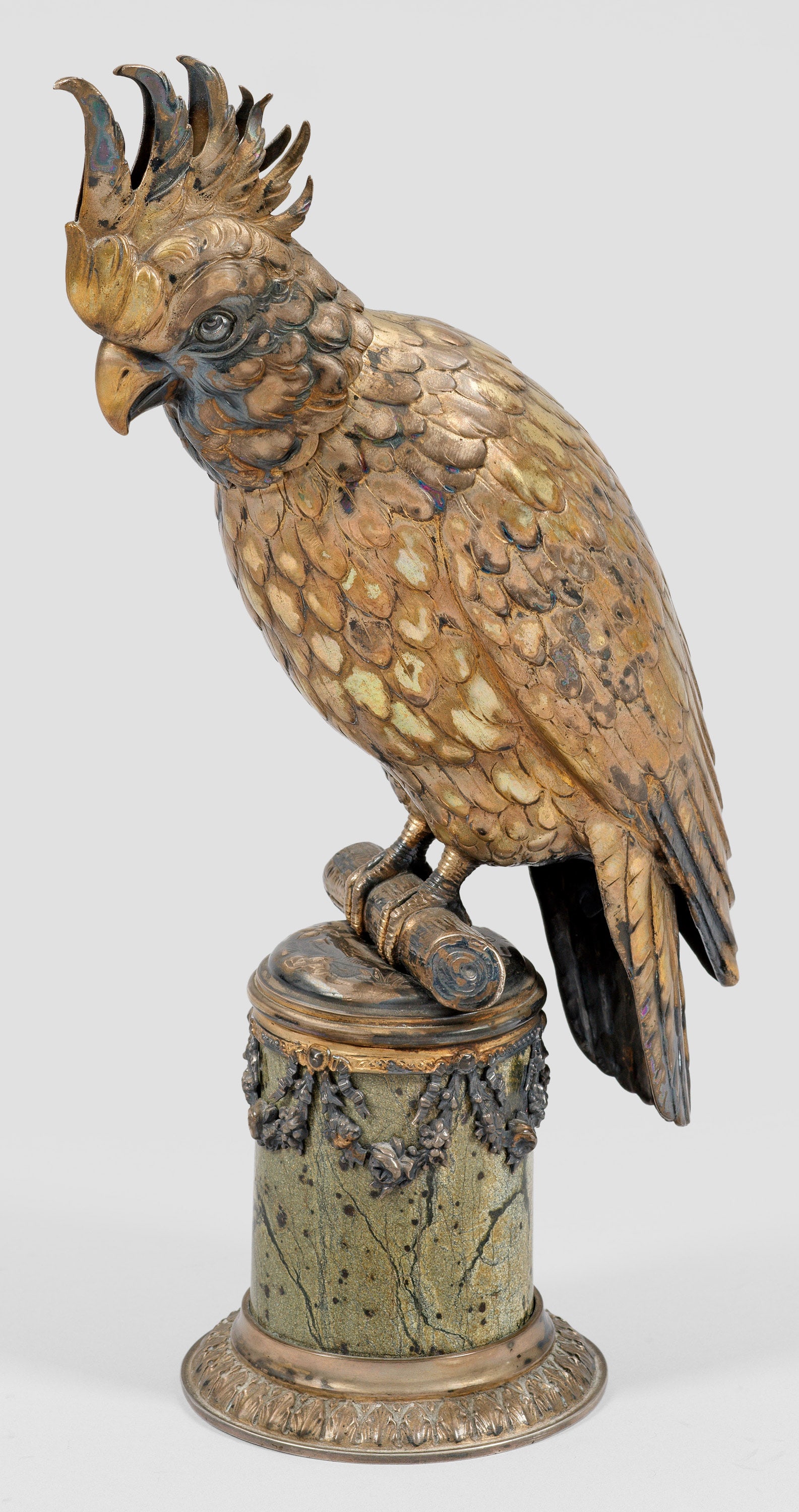 Historismus-Trinkspiel in Form eines Kakadus: Silber, Achat. Über silbermontierter, zylindrischer Achatsäule mit umlaufenden Blütenfestons und von Palmetten gesäumtem Standring sitzender Kakadu mit naturalistisch gestaltetem Gefieder, gesträ