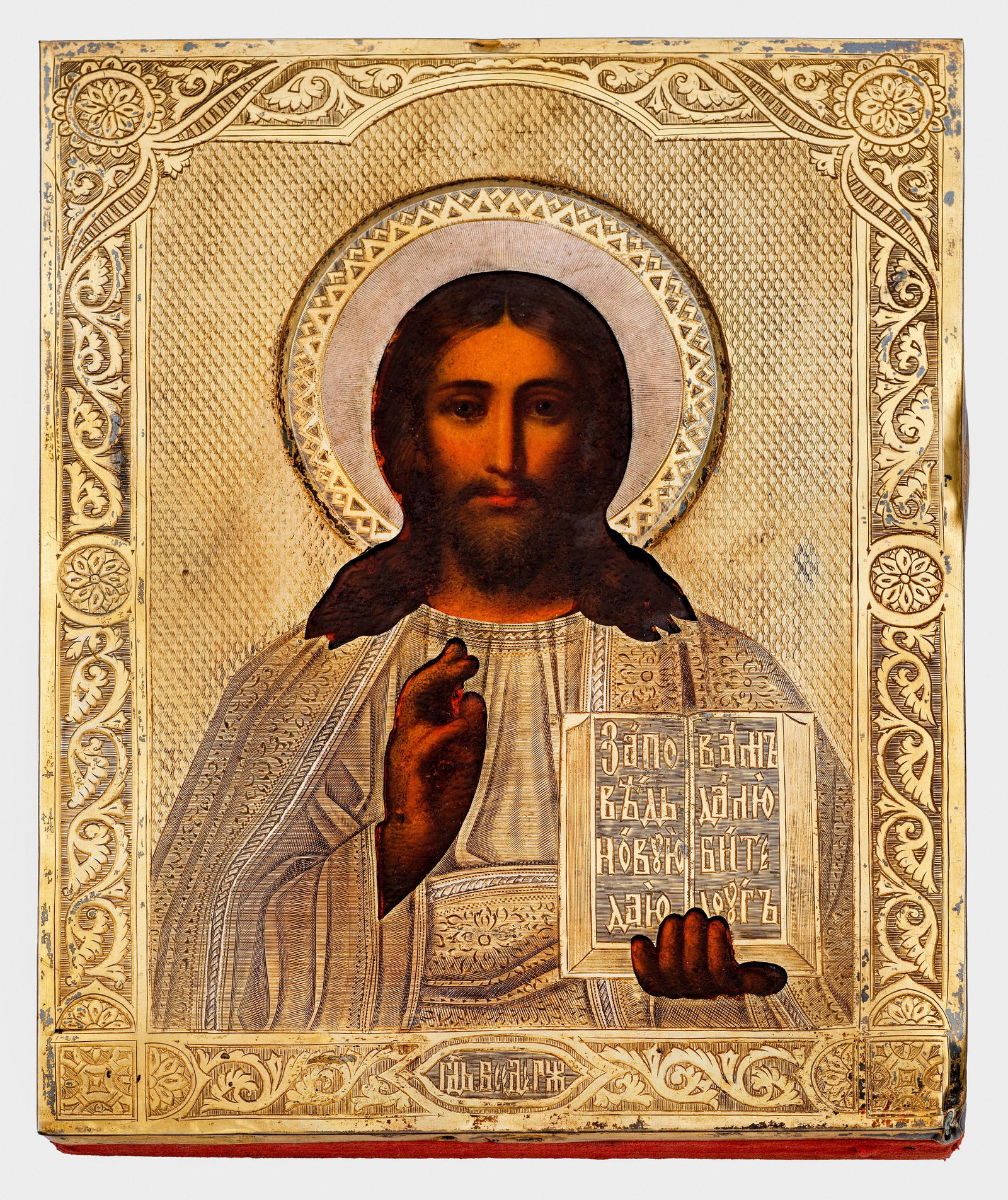 Kleine Ikone "Christus Pantokrator": Tempera auf Holz mit vergoldetem Silberoklad. Fein graviertes Oklad aus dünnem Silberblech mit ornamentalem Randfries und Beschriftung. Rückseite mit rotem Samtstoff bezogen. Gest. 84, Beschauzeiche
