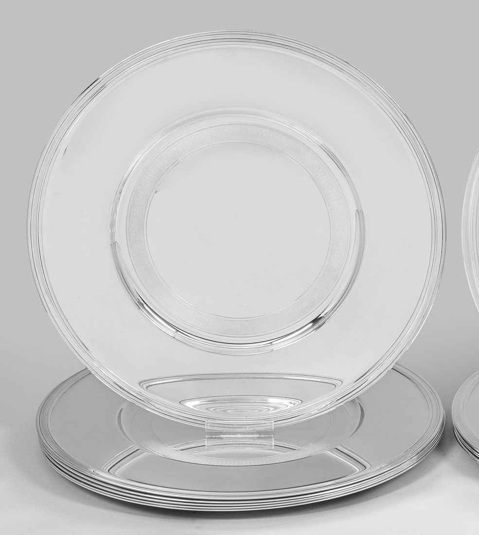 Satz von sechs Platztellern von Christofle: Plated. Flache, runde Form mit breiter, mehrfach randprofilierter Fahne und minimal vertieftem Spiegel mit feiner Gitterbandbordüre. Dekor "Albi". Teilw. Gebrauchsspuren. Gem. Herstellerzeichen. D. 3