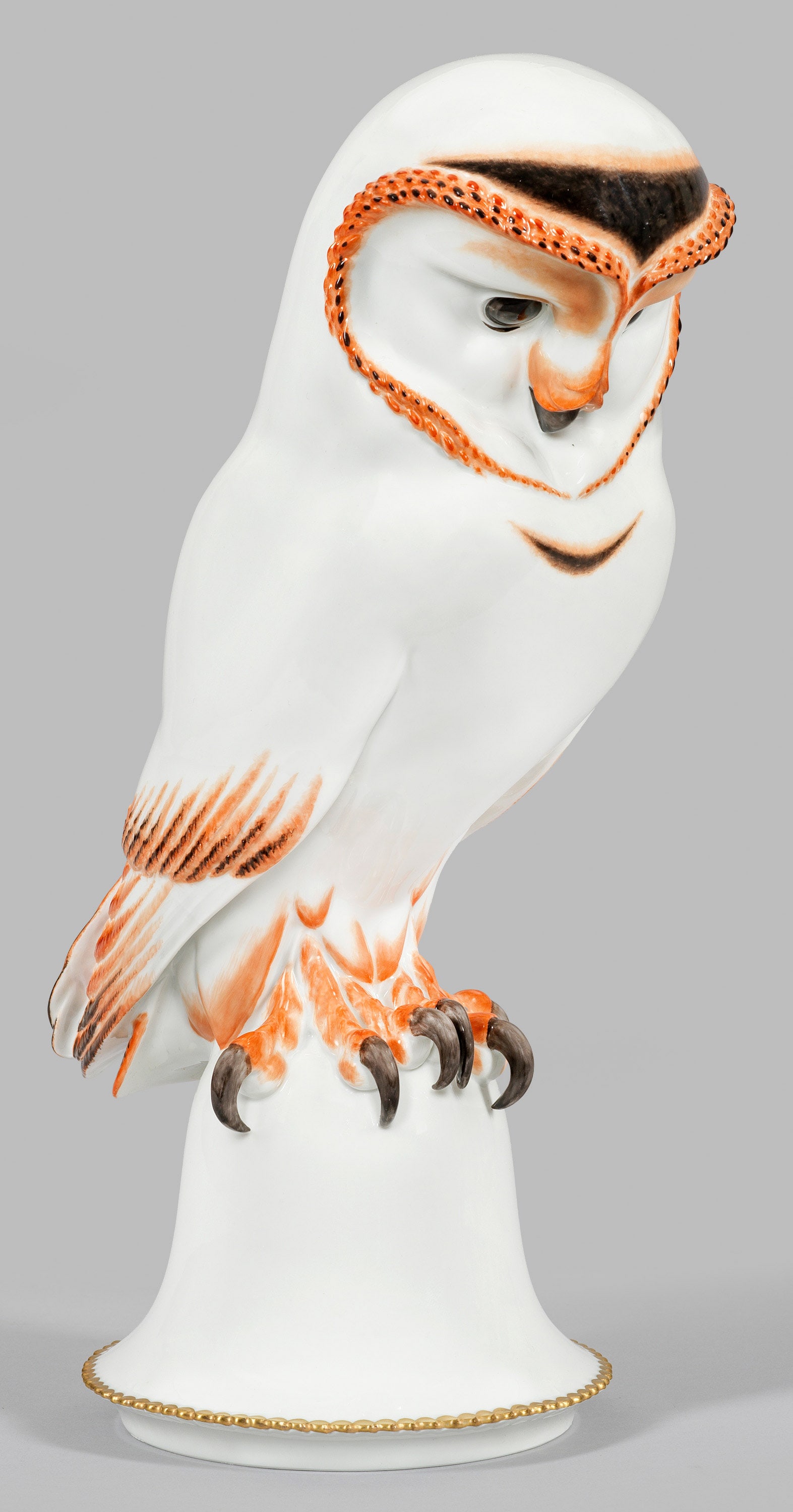 Art-Déco Eule von Meissen: Auf glockenförmigem Sockel mit vergoldetem Zackenfries sitzende Eule. Dezente polychrome Malerei, überwiegend in Eisenrot, Schwarz und Grau. Entw. Max Esser. Entw.-Bez.; Modell-Nr. 77245. Schwerterm
