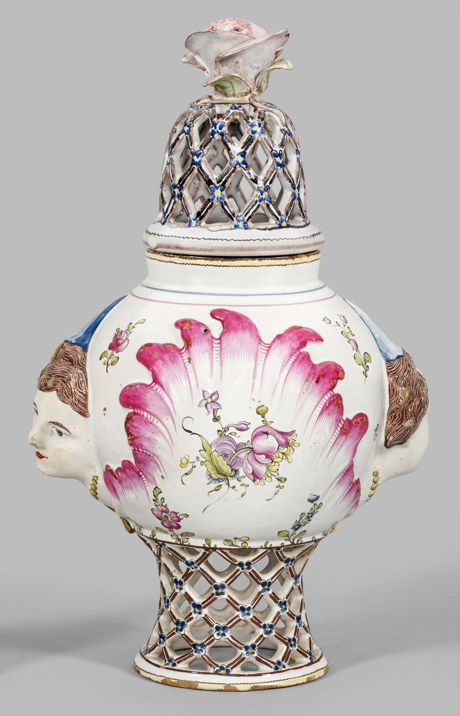 Potpourri-Vase mit Netzdekor: Fayence. Balusterform. Standring und Deckel netzartig duchbrochen gearbeitet, in den Schnittpunkten Vergissmeinnicht-Blüten. Beidseitig zentral des Korpus von Muschelrelief eingefasste Blumengebinde,