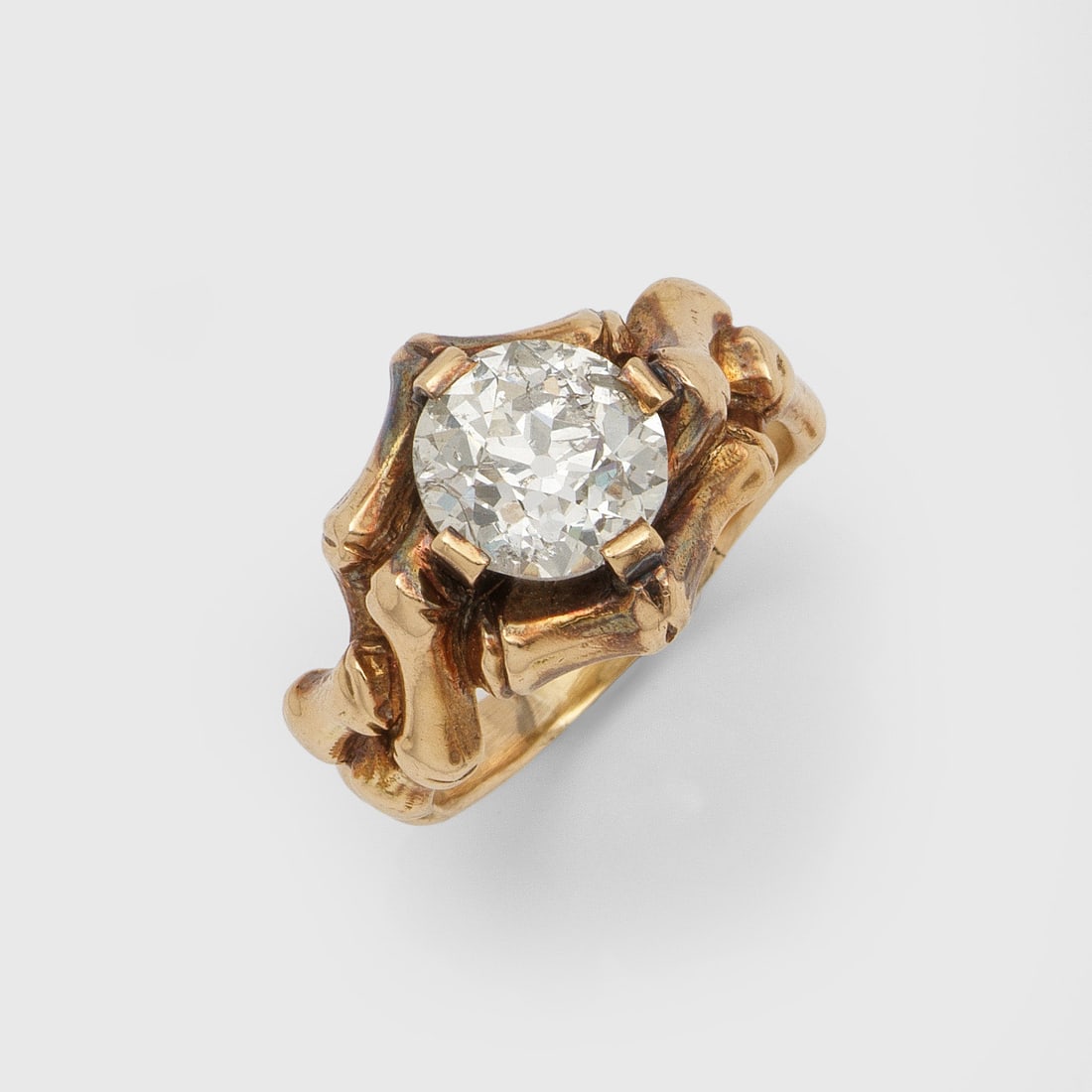 Belle Epoque Herrenring mit Diamantsolitär: Roségold, 14 ct.; Plastisch gestaltete Ringschiene aus stilisierten Knochen, symbolisierend das "Momento Mori", besetzt mit Altschliffdiamanten von ca. 3,00 ct., Gew. ca. 8,69 g. Belle Epoque