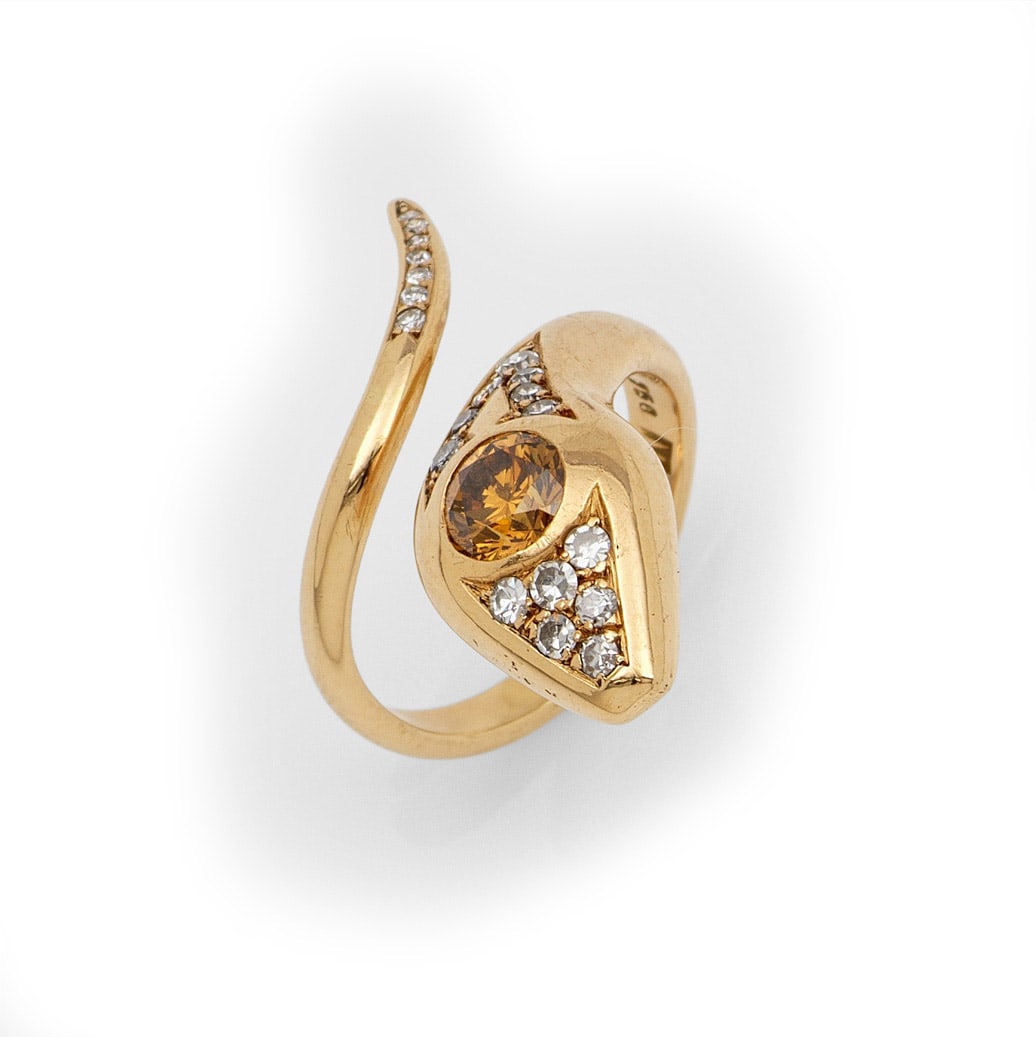 Dekorativer Schlangenring: Gelbgold, gest. 750. Plastisch gestaltete Schlangenform, besetzt mit einem orange-gelben Citrin von ca. 0,50 ct. und 8/8 Diamanten. Gew. ca. 6,73 g. Snake ring set with a orange yellow citrine approx.