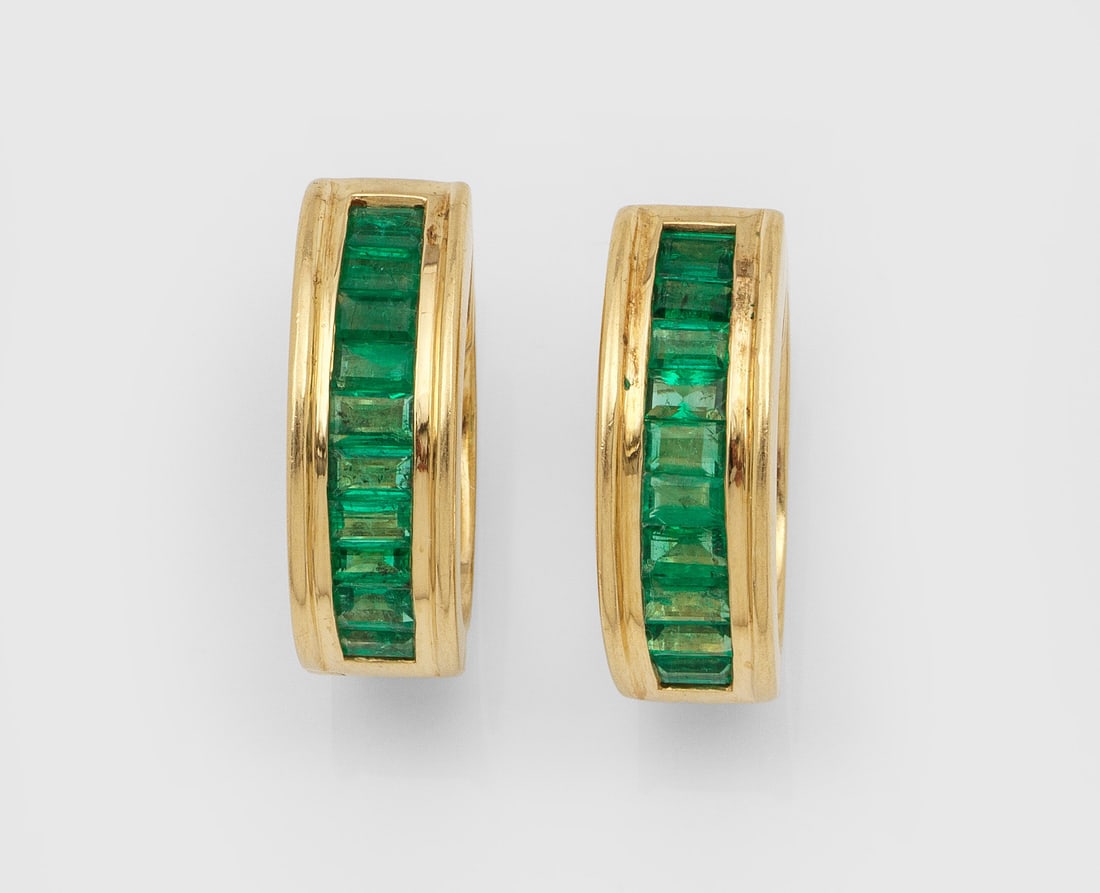 Paar klassische Creolen mit Smaragden: Gelbgold, gest. 750. Schauseitig in sog. Kanalfassung leuchtendgrüne Smaragd-Carrées von zus. ca. 2,40 ct.; Ges.-Gew. ca. 14,94 g. Pair of earrings set with emeralds approx. 2,40 ct., in 18 k gold.