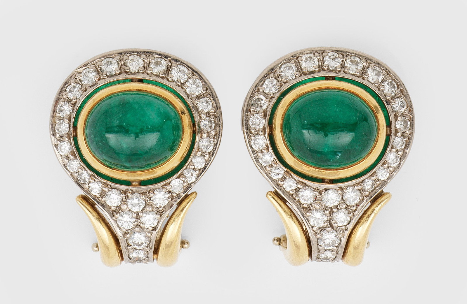 Paar klassische Smaragd-Brillant-Ohrclips: Gelb- und Weißgold, gest. 750. Zentral besetzt mit 2 tannengrünen Smaragd-Cabochons, entouriert von Brillanten von zus. ca. 1,50 ct. (H/vs-si). Ges.-Gew. ca. 18,44 g. Pair of earclips set with 2 eme
