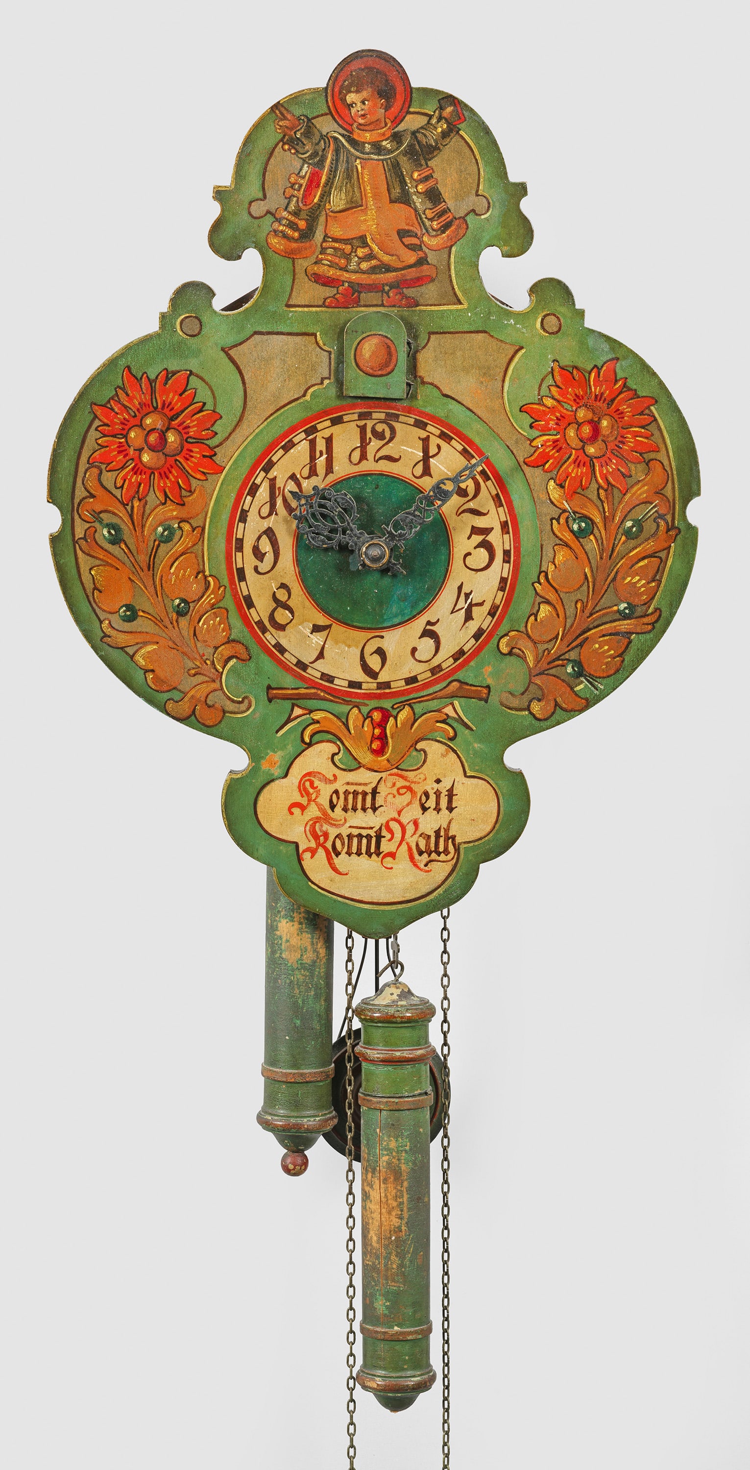 Kuckucksuhr: Holz, schauseitig polychrom gestaltet. Kartuschenförmiges Zifferblatt mit Darstellung des Münchner Kindls sowie Sinnspruch "Kommt Zeit kommt Rath". Messingwerk mit Schlag auf Tonfeder sowie Kuckuck.