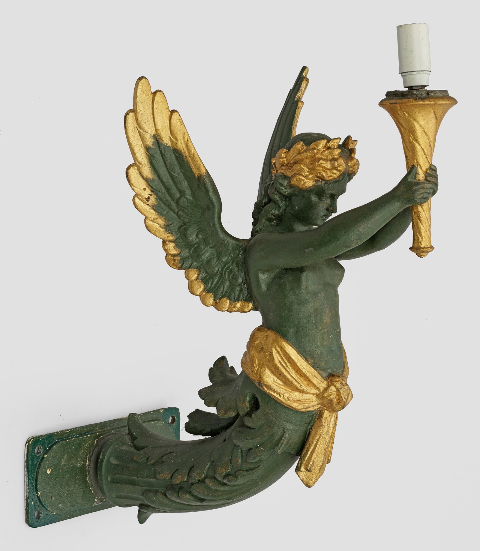 Belle Epoque-Wandlampe: 1-flg.; Metall, grün und teilw, goldfarben lackiert. Vollplastische Darstellung einer Genie mit üppigem Akanthusblatt, eine stilisierte Fackel emporhaltend. Elektrifiziert. H. 35 cm. A French green 