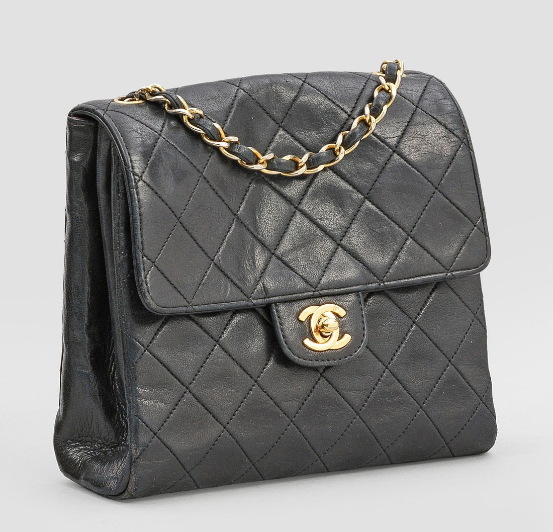 "Timeless Flap Bag" von CHANEL: Schwarzes, bzw. bordeauxrotes Lammleder in charakteristischer Rautensteppung und vergoldete Hardware. Rechteckiger leicht konischer Korpus mit CC-Logo Drehverschluss. Großes Innenfach mit zwei Seiten