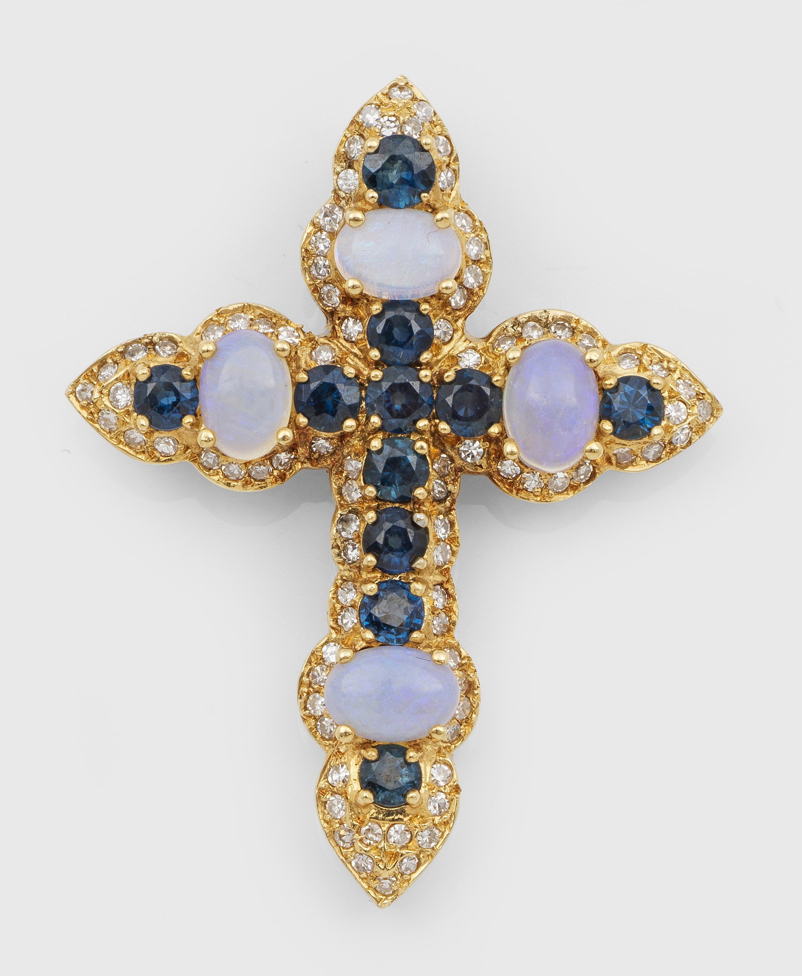 Kreuz-Anhänger mit Mondsteinen und Saphiren: Gelbgold, gest. 18 ct.; Schauseitig besetzt mit Mondstein-Cabochons, tintenblauen Saphiren und kleinen Diamanten. Gew. ca. 10,22 g. Cross pendant set with moonstones, sapphires and small diamonds, in 