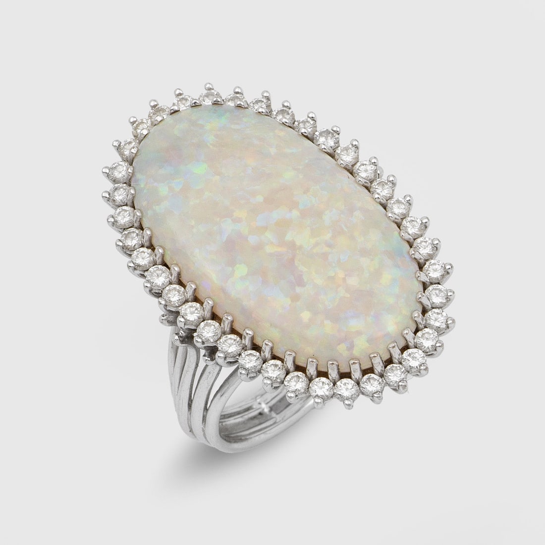 Marquise-Brillantring mit Opal: Weißgold, 18 ct.; Zentral besetzt mit einem Weißopal von sehr feinem Farbspiel, entouriert von Brillanten von zus. ca. 0,38 ct.; Gew. ca. 9,93 g. Ring set with an opal and diamonds approx. 0,38