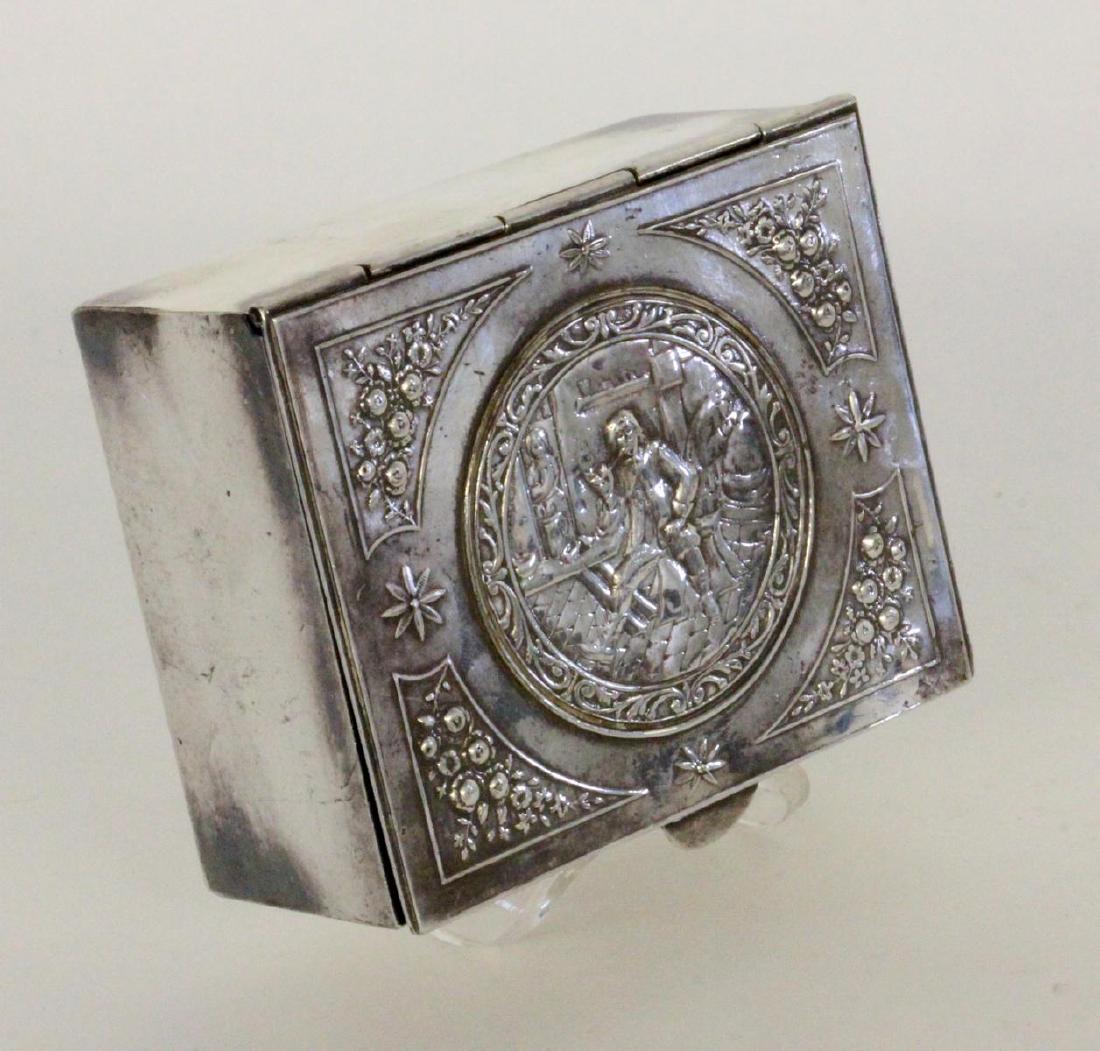 A CIGARETTE BOX Paris circa 1900 Silver-plated: A CIGARETTE BOX Paris circa 1900 Silver-plated metal. Hinged lid. Relief decor with pipe smoker in tavern. Marked on the lid. 4.8 x 11 x 9 cm