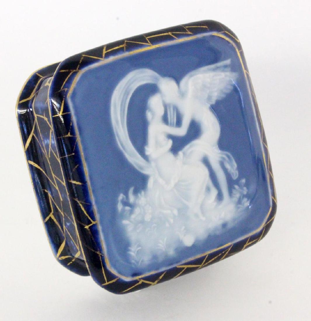 A BOX WITH COVER Limoges, France Cupid and: A BOX WITH COVER Limoges, France Cupid and Psyche. Blue background with white relief decoration in pate-sur-pate and gold decoration. Hallmarked.