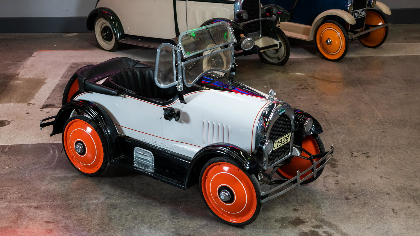 1928 Cadillac Toledo Pedal Car: Lot S65.1 - 1928 Cadillac Toledo Pedal Car HIGHLIGHTS Original* Restored Toledo Features: Horn, full suspension, spare tire and spotlight Color(s): Tan and orange Metal body Steering wheel (in): 9 Whe