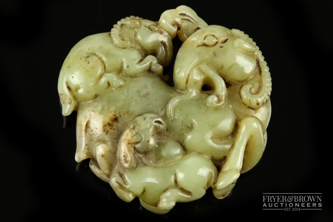 A Chinese mutton fat jade carving of a goat and two: A Chinese mutton fat jade carving of a goat and two young, the mixed mottled celadon jade carved in the 17th century style, 5.5cm approx.