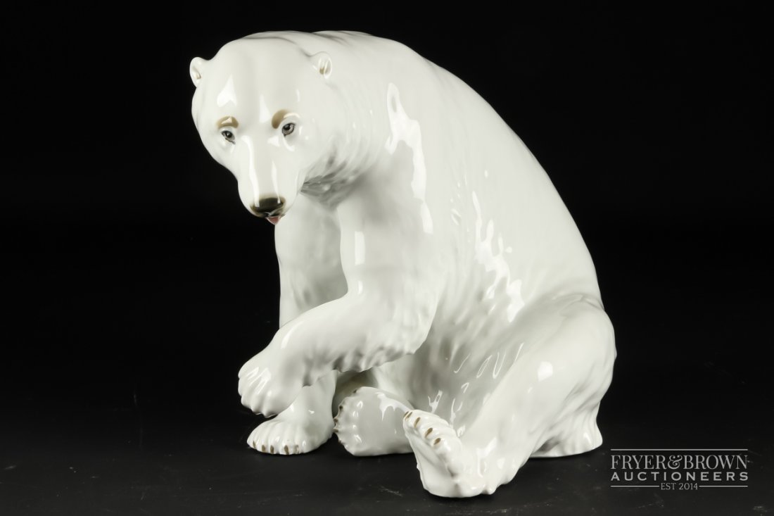 A Continental porcelain figure of a seated polar bear,: A Continental porcelain figure of a seated polar bear, blue printed B under crown mark, 18cm high