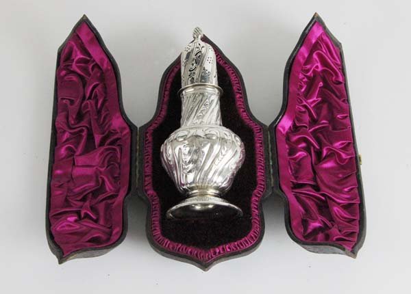 A 19thC silver sugar castor, London 1888, makers mark: A 19thC silver sugar castor, London 1888, makers mark C.S.H for Charles Stuart Harris, chased with scroll decoration and pierced top in original satin velvet and tooled leather fitted case, total silv