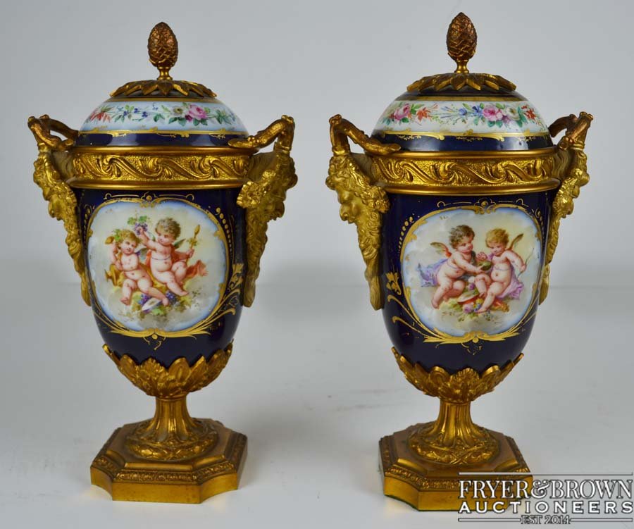 A pair of ormolu mounted Paris porcelain vases and: A pair of ormolu mounted Paris porcelain vases and covers, the porcelain painted in Sevres style with reserves of putti with summer flowers verso within gilded 'c' scroll reserves in deep cobalt blue 