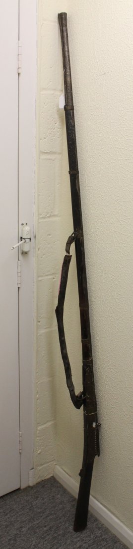 A Indo-Afghan Jezail type musket, with pinprick: A Indo-Afghan Jezail type musket, with pinprick decoration and original leather carrying strap, barrel length 140cm approx