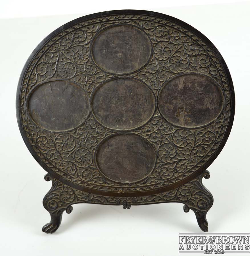 An Indian ebony wood miniature frame, oval on two (1 of 1)