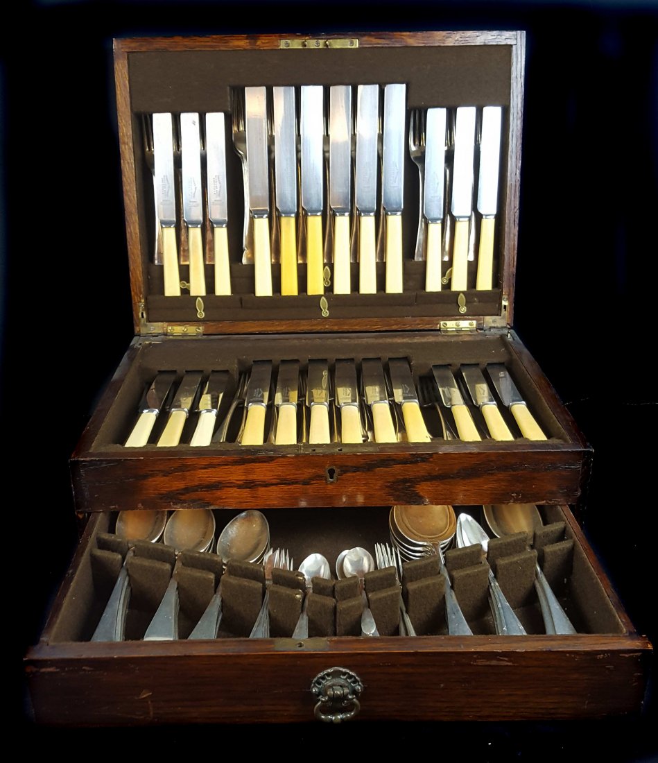 A quantity of silver plated cutlery; and a carved oak (1 of 2)
