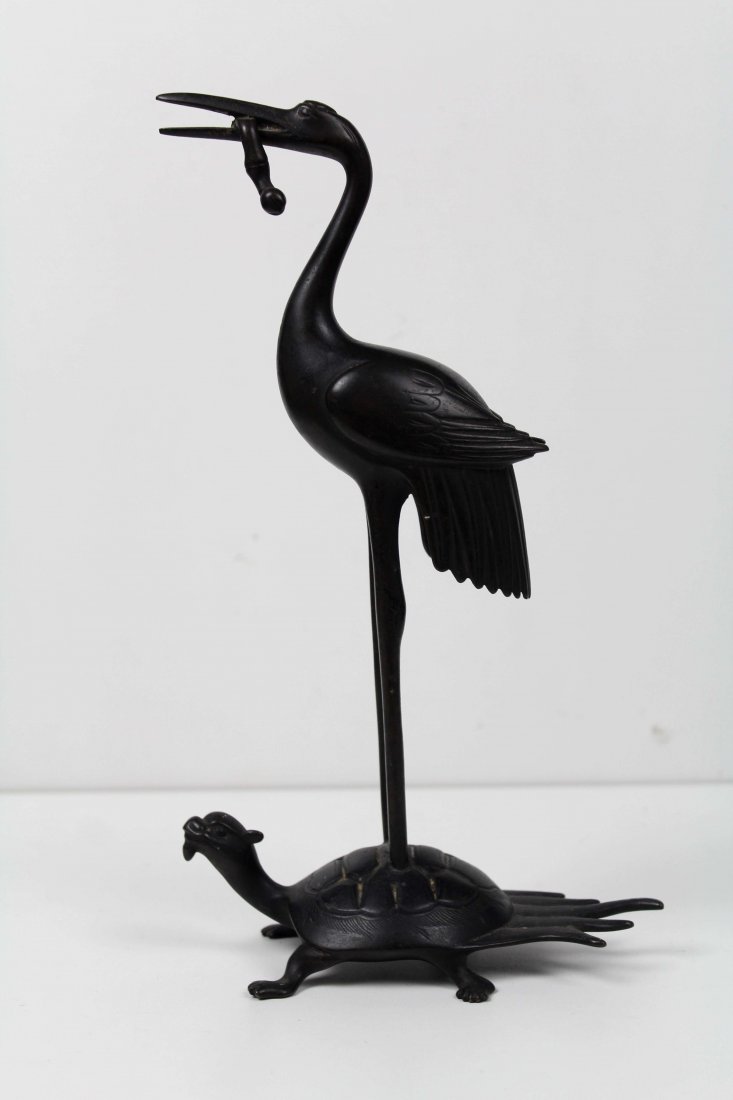 A Japanese bronze of a crane with eel in its beak, atop: A Japanese bronze of a crane with eel in its beak, atop a minogame turtle, 26.5cm high