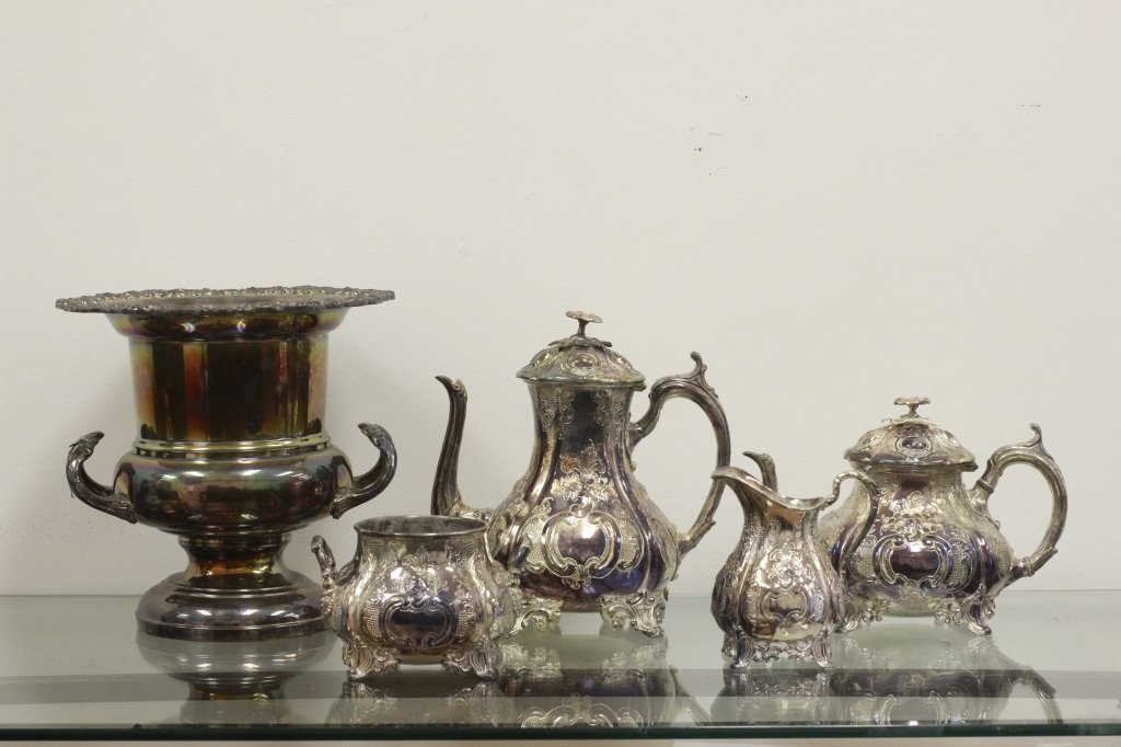 Silver Plated Tea Set w/ Silver Plated Wine Cooler: 4 Piece Silver Plated Tea Set w/ Silver Plated Wine Cooler. Tea Set includes 1 Coffee Pot, 1 Tea, 1 Milk and 1 Sugar. 5 Pieces Total including Wine Cooler. Dimensions of Cooler- H-10" x Diam-9.5". Dim