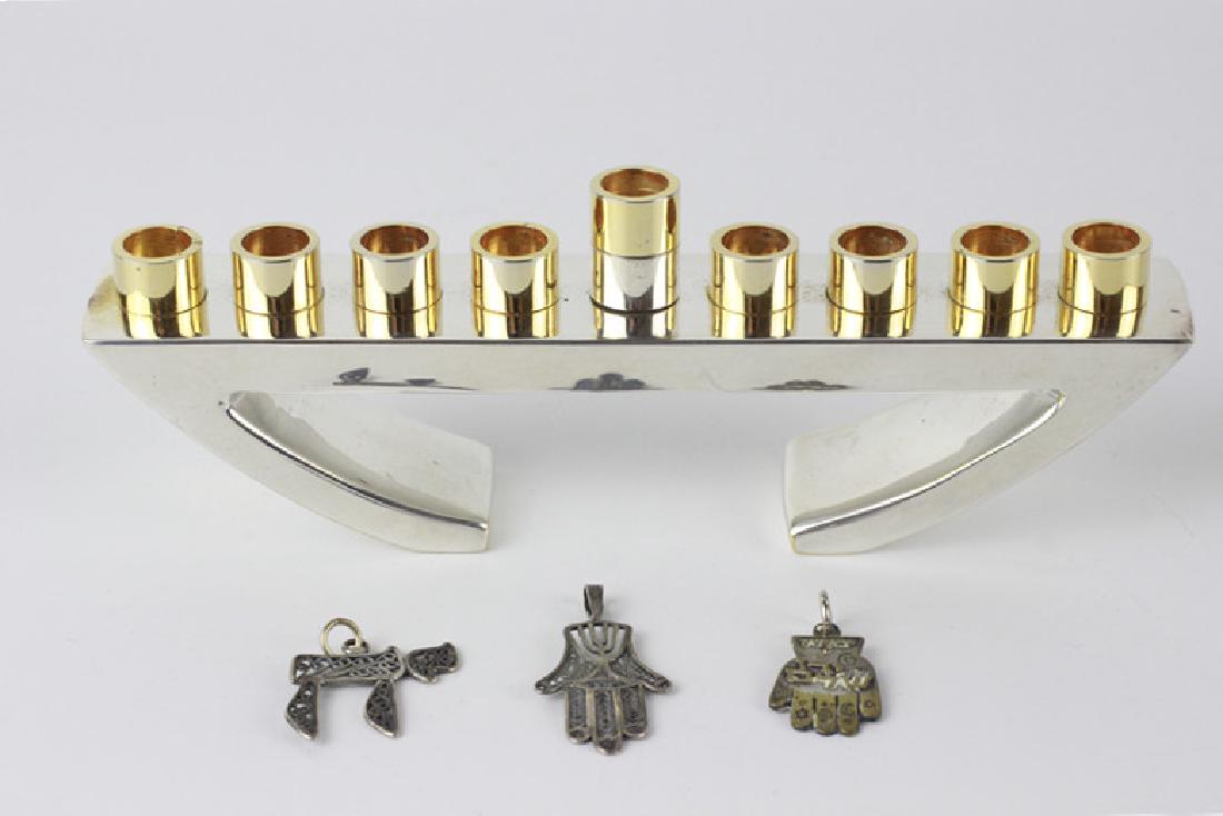 Lot of Judaica Items: Lot of Judaica Items Including: 2 Silver Pendants, 1 Non-Silver Pendant, 1 Heavy Menorah by Steve Klein in Original Box. Menorah Dimension- L-6" x H-1.5"