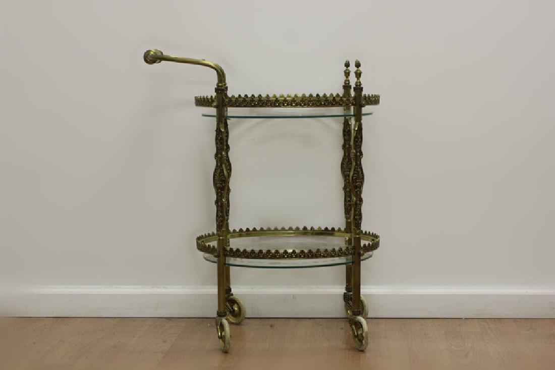 Gilt Metal Double Tier Tea Cart w/ Glass: Gilt Metal Double Tier Tea Cart w/ Glass. Dimensions- H-27" Dia-17.5".