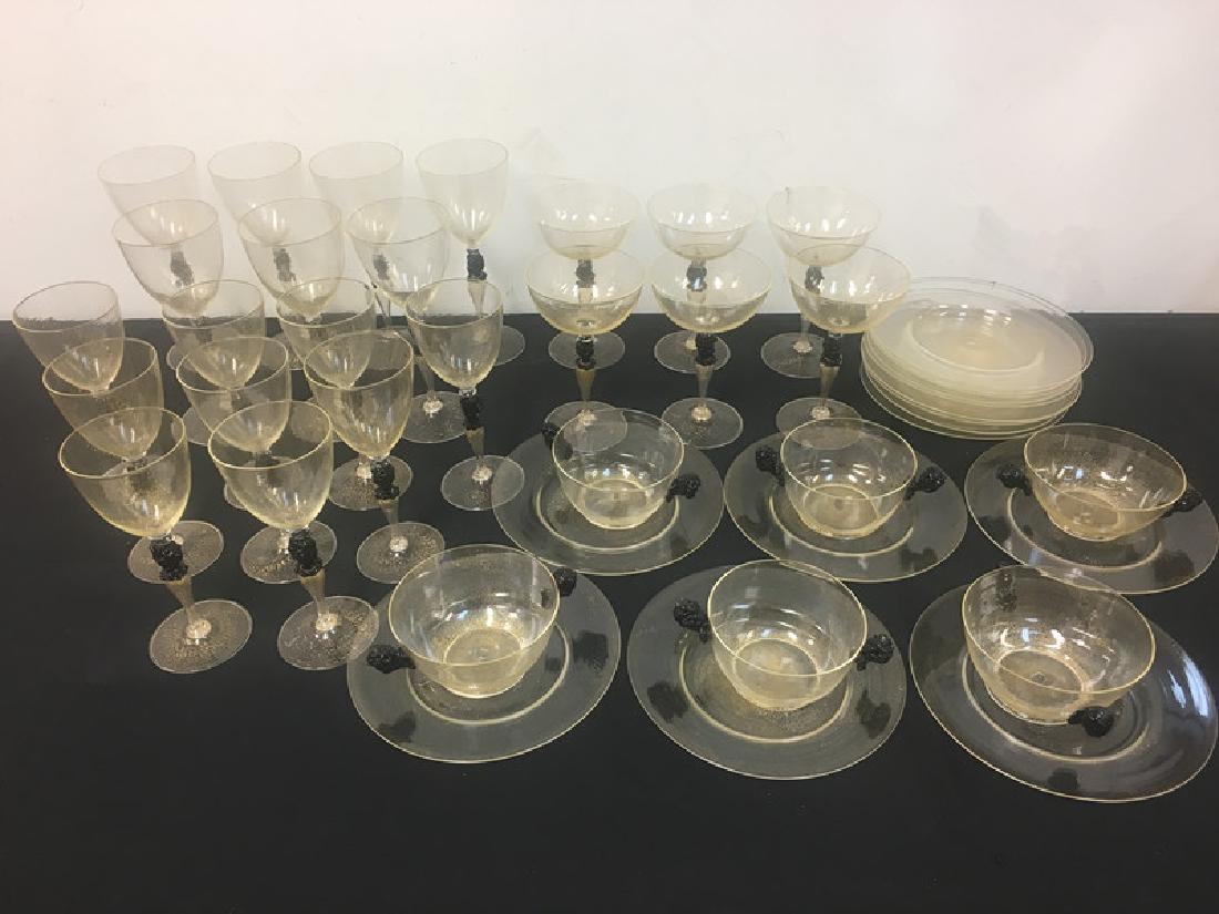 43 Piece Venetian Glass Set, Circa 1940's: 43 Piece Venetian Glass Set, Circa 1940's, Including 7 Water Glasses, 9 Wine Glasses, 6 Champagne Glasses, 6 Compotes w/ Underplates & 9 Extra Underplates, w/ Blackamoor & Gold Powder Decoration.